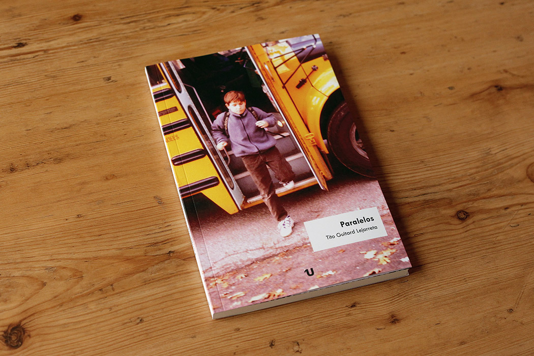 Portada del libro "Paralelos" de Tito Guitard Lejarreta, que muestra una foto a página completa de un niño (de los años ochenta) bajando de un autobús escolar amarillo.